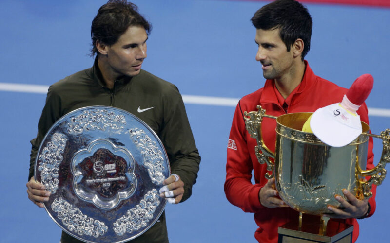 Spain's Rafael Nadal and Novak Djokovic of Serbia pose with their trophies after their men's singles final match at the China Open tennis tournament in Beijing