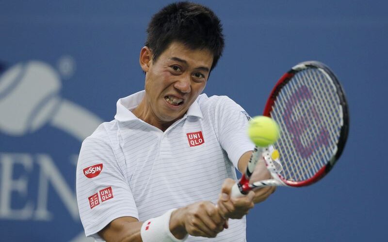 Nishikori of Japan hits a return to Wawrinka of Switzerland during their quarter-final match at the 2014 U.S. Open tennis tournament in New York