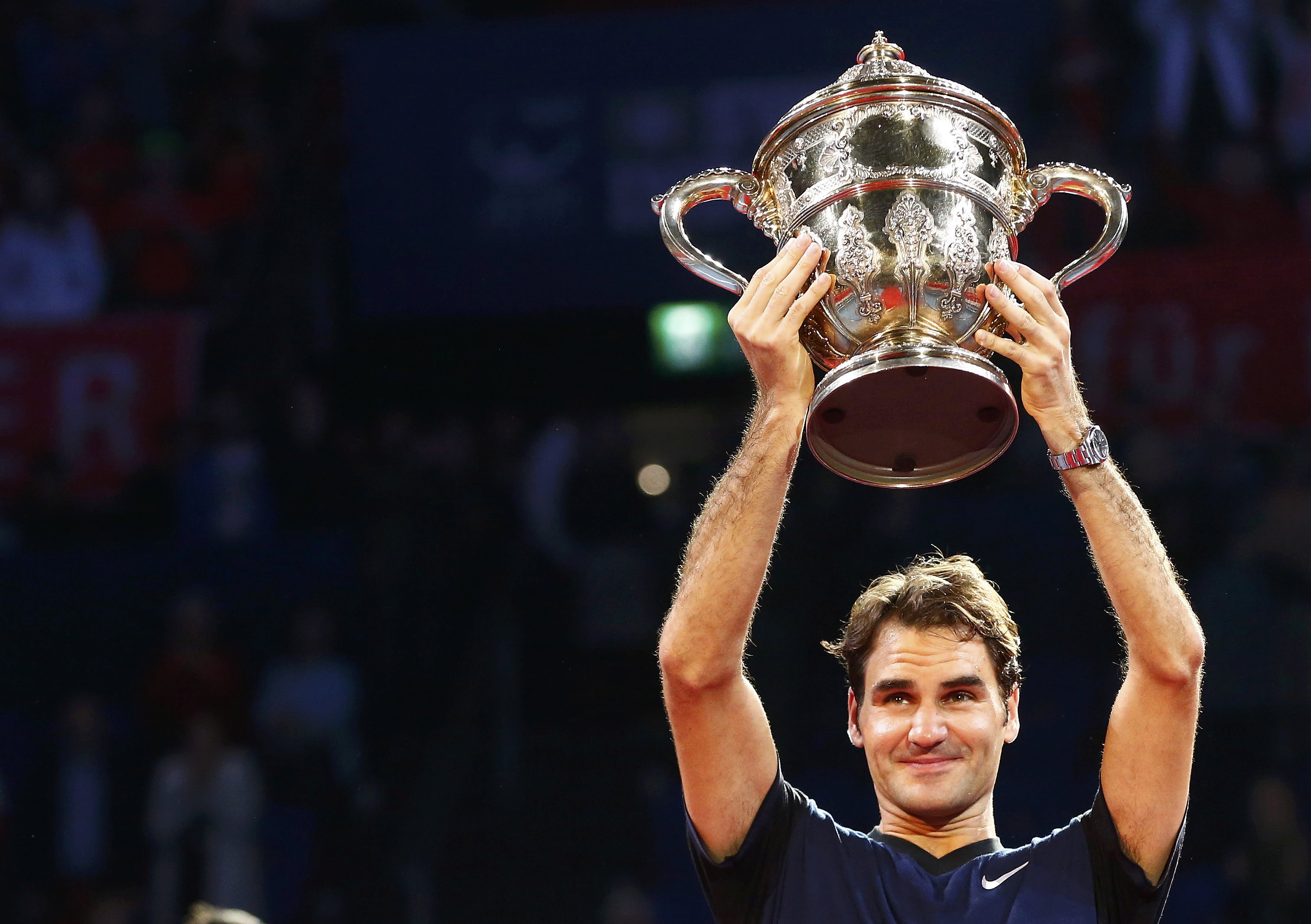 Switzerland's Federer holds the trophy after winning his match against Nadal of Spain at the Swiss Indoors ATP men's tennis tournament in Basel