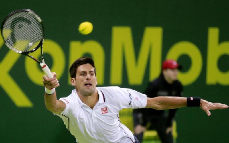 Novak Djokovic of Serbia hits a return to Croatia's Ivo Karlovic during their quarterfinal match at the Qatar Open tennis tournament in Doha