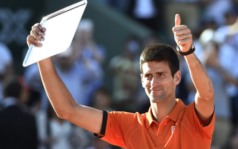 Serbia's Novak Djokovic holds up the runner-up trophy following his defeat against Switzerland's Stanislas Wawrinka at the end of their men's final match of the Roland Garros 2015 French Tennis Open in Paris on June 7, 2015.  AFP PHOTO / DOMINIQUE FAGET        (Photo credit should read DOMINIQUE FAGET/AFP/Getty Images)