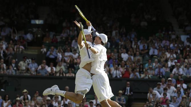 Bob Bryan and Mike Bryan of the United States celebrate after beating Ivan Dodig of Croatia and Marcelo Melo Brazil to win the Men's doubles final match at the All England Lawn Tennis Championships in Wimbledon, London, Saturday, July 6, 2013. (AP Photo/Anja Niedringhaus)