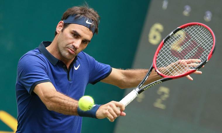 Roger Federer of Switzerland  returns a ball  in the match against Jan-Lennard Struff of Germany during the Gerry Weber Open ATP tennis tournament in Halle, Germany, Wednesday June 15, 2016. (Friso Gentsch/dpa via AP)