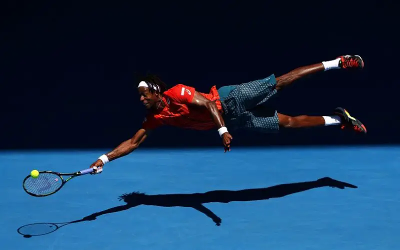 XXX of ZZZ plays a forehand in his/her fourth round match against XXXX of ZZZZ during day eight of the 2016 Australian Open at Melbourne Park on January 25, 2016 in Melbourne, Australia.