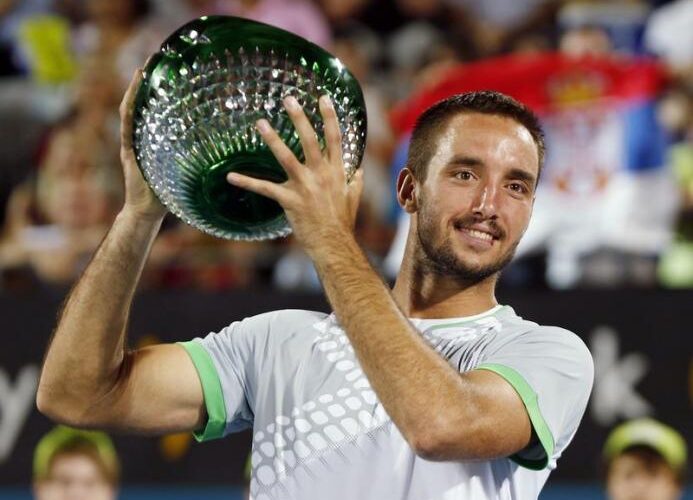Viktor Troicki of Serbia holds the men's singles trophy after defeating Mikhail Kukushkin of Kazakhstan at the Sydney International tennis tournament in Sydney, January 17, 2015.    REUTERS/Jason Reed