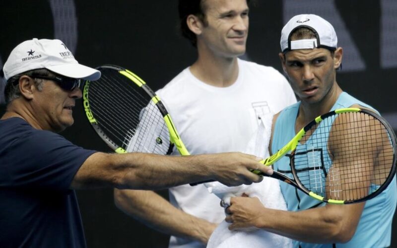 Spain s Rafael Nadal  right  talks with his uncle Toni Nadal  left  as coach Carlos Moya looks on during a practice session ahead of the Australian Open tennis championships in Melbourne  Australia  Sunday  Jan  15  2017   AP Photo Aaron Favila
