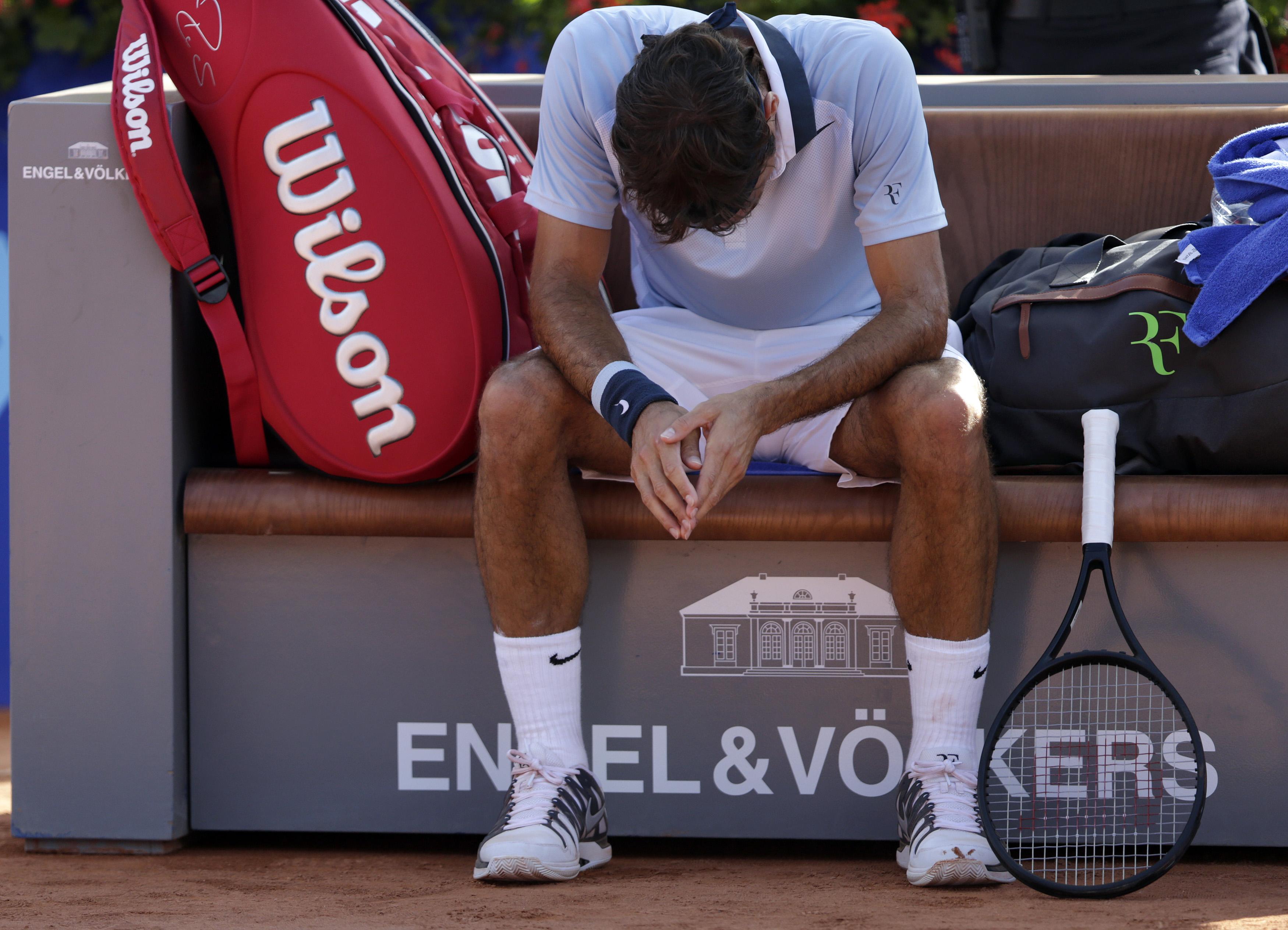 Switzerland's Roger Federer reacts during a break during his Swiss Open second round tennis match against Germany's Daniel Brands in Gstaad