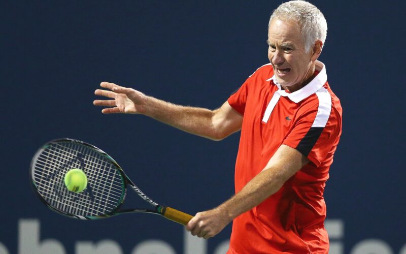 NEW HAVEN, CT - AUGUST 28:  John McEnroe returns a shot to Jim Courier as part of the Men's Legends presented by PowerShares Series at the Connecticut Open at Connecticut Tennis Center at Yale on August 28, 2015 in New Haven, Connecticut.  (Photo by Maddie Meyer/Getty Images)