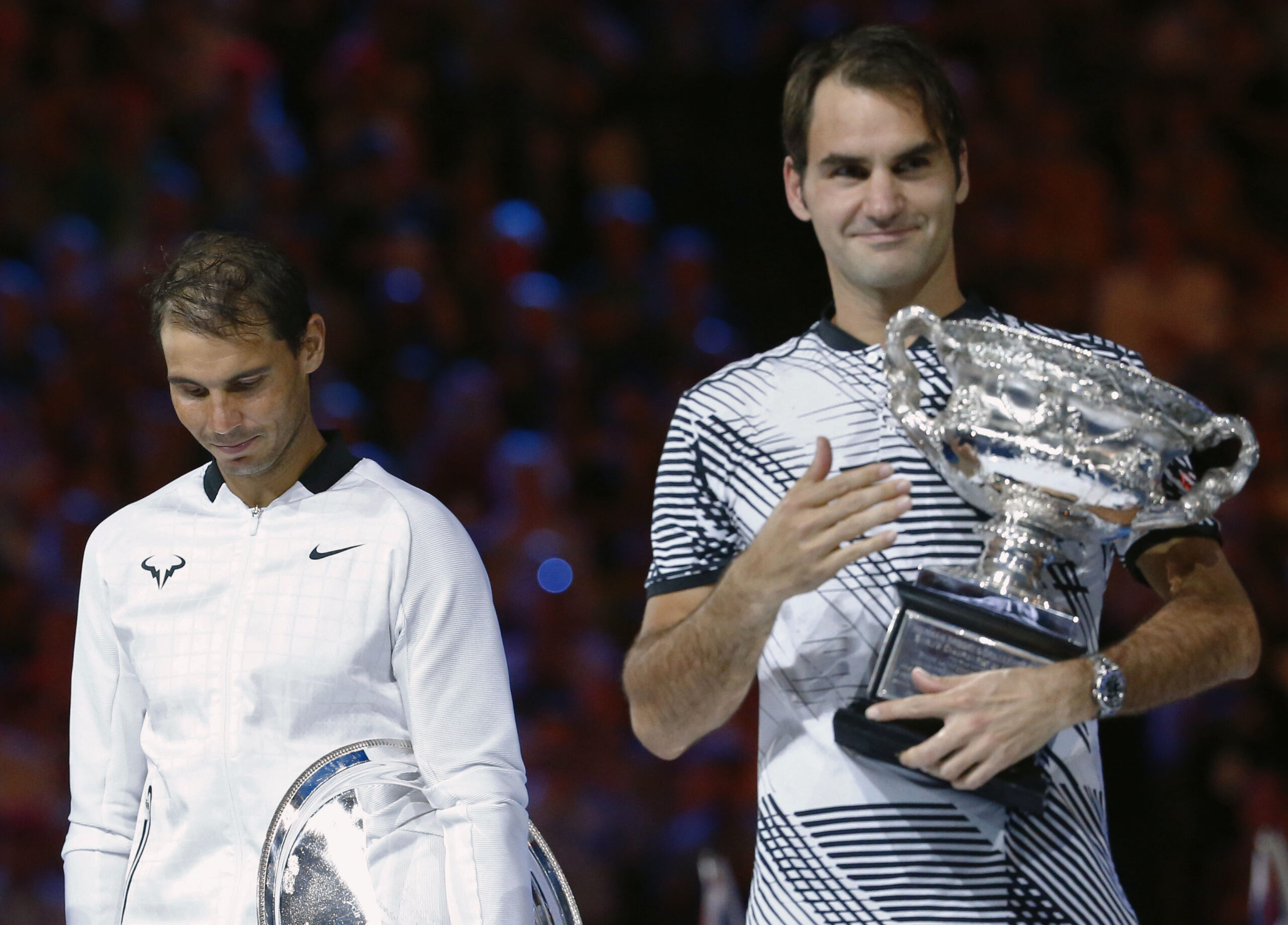 Tennis - Australian Open - Melbourne Park, Melbourne, Australia - 29/1/17 Spain's Rafael Nadal reacts next to Switzerland's Roger Federer who is holding the trophy after winning his Men's singles final match. REUTERS/Edgar Su - RTSXW78
