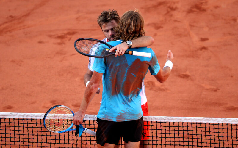 PARIS, FRANCE - JUNE 02: Stefanos Tsitsipas of Greece embraces Stan Wawrinka of Switzerland following their mens singles fourth round match during Day eight of the 2019 French Open at Roland Garros on June 02, 2019 in Paris, France. (Photo by Adam Pretty/Getty Images)