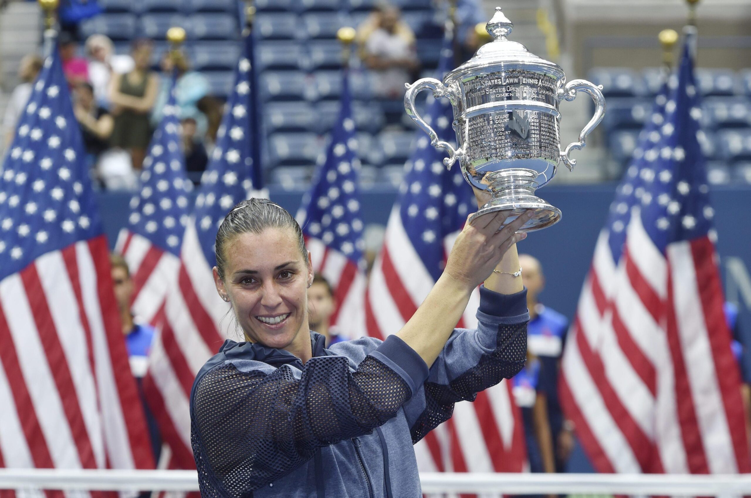 epa04927992 Flavia Pennetta of Italy celebrates with the championship trophy after defeating Roberta Vinci of Italy in the women's final on the thirteenth day of the 2015 US Open Tennis Championship at the USTA National Tennis Center in Flushing Meadows, New York, USA, 12 September 2015. The US Open runs through 13 September, which is a return to a 14-day schedule.  EPA/JUSTIN LANE