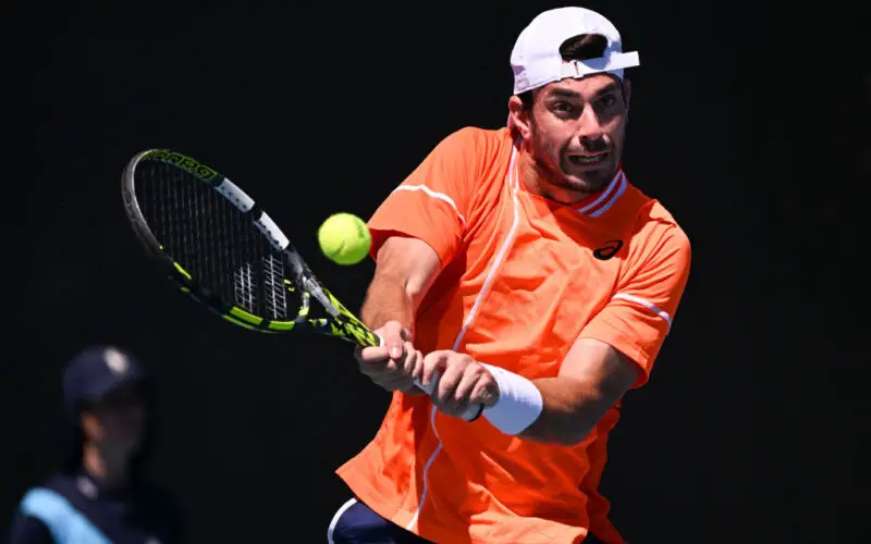 Italy's Giulio Zeppieri hits a return against Serbia's Dusan Lajovic during their men's singles match on day three of the Australian Open tennis tournament in Melbourne on January 16, 2024. (Photo by WILLIAM WEST / AFP) / -- IMAGE RESTRICTED TO EDITORIAL USE - STRICTLY NO COMMERCIAL USE -- (Photo by WILLIAM WEST/AFP via Getty Images)