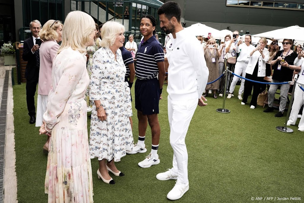 Britain's Queen Camilla (C) meets with Serbia's Novak Djokovic (R) upon her arrival for the tenth day of the 2025 Wimbledon Championships at The All England Lawn Tennis and Croquet Club in Wimbledon, southwest London, on July 9, 2025. 
Jordan Pettitt / POOL / AFP